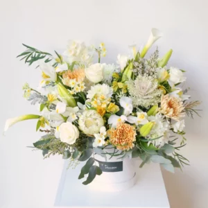 Boxed Love garden-style hatbox arrangement in soft white and apricot flowers – Christchurch florist