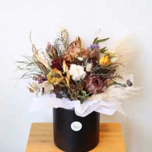 Dried flower arrangement in black hat box, natural earthy tones, everlasting gift bouquet Christchurch