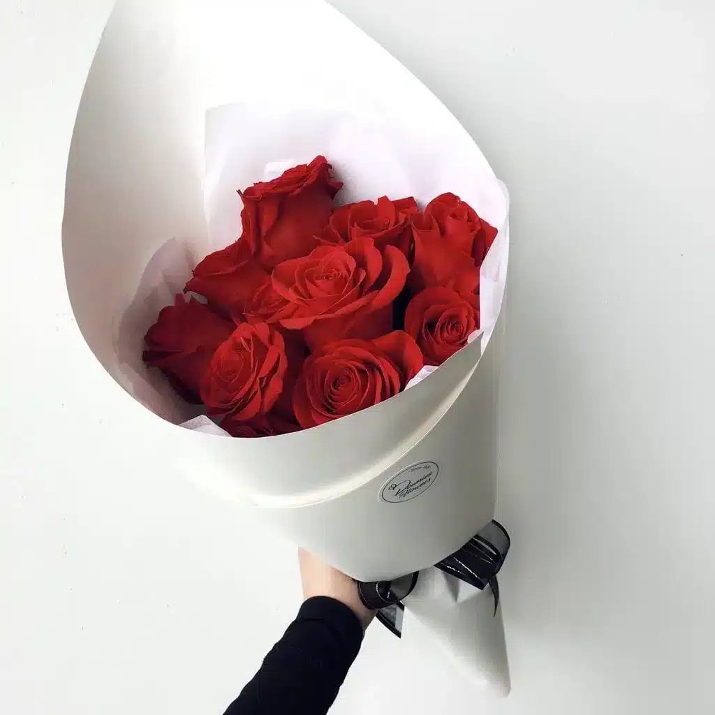 Rose Only bouquet with premium red roses — minimalist modern wrap, no fillers