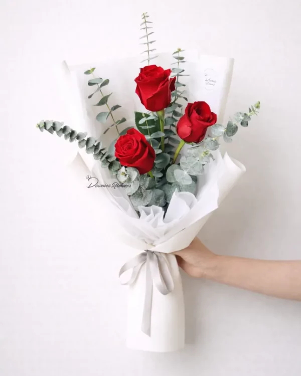 Three red roses bouquet wrapped with foliage – The Three Words, Christchurch florist