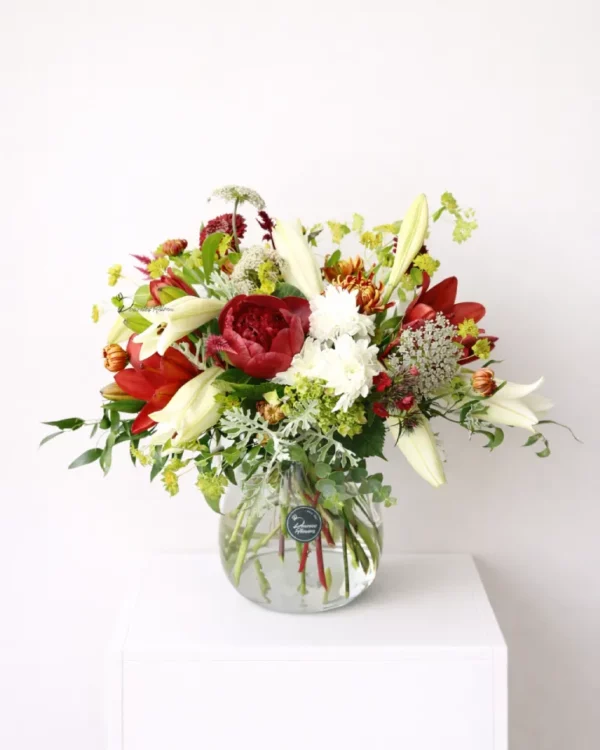 Harvest Christmas vase arrangement with festive red, green, and white seasonal flowers – Christchurch florist