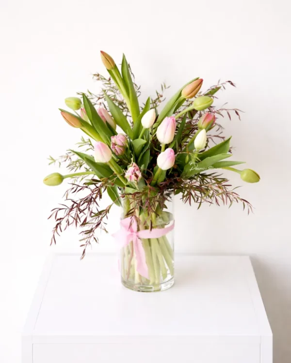 Mixed tulips arranged in a clear glass vase, styled for delivery in Christchurch