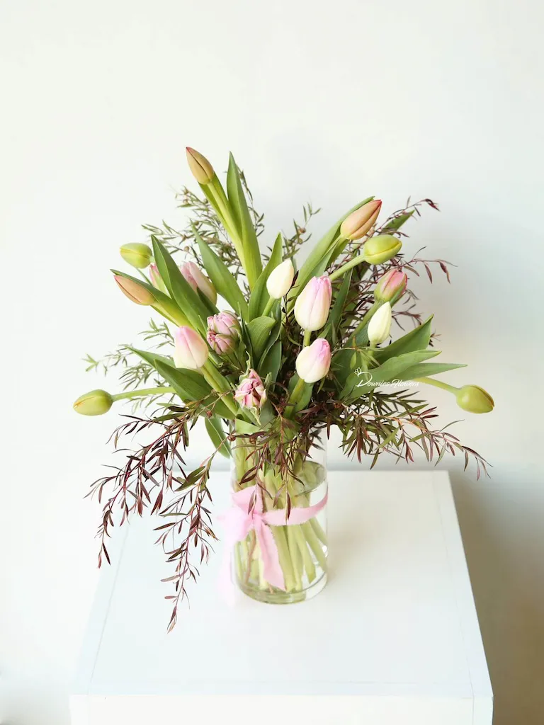 Mixed tulips arranged in a clear glass vase, styled for delivery in Christchurch