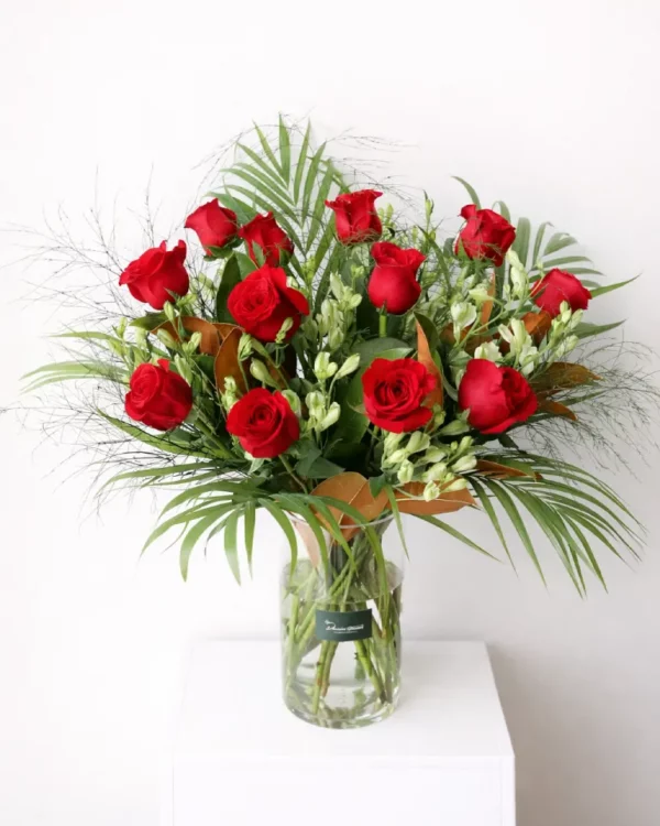 Roses in Vase — 12 red roses arranged with greenery in clear glass vase