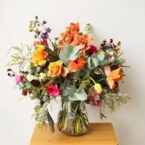 Harvest vase arrangement with bright seasonal flowers and natural textures – Christchurch florist