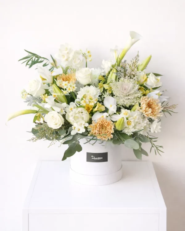 Boxed Love garden-style hatbox arrangement in soft white and apricot flowers