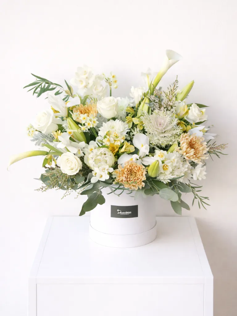 Boxed Love garden-style hatbox arrangement in soft white and apricot flowers