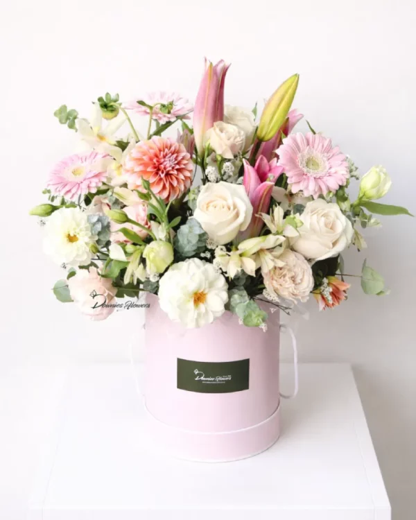 garden style boxed flower arrangement soft pastel seasonal flowers hatbox