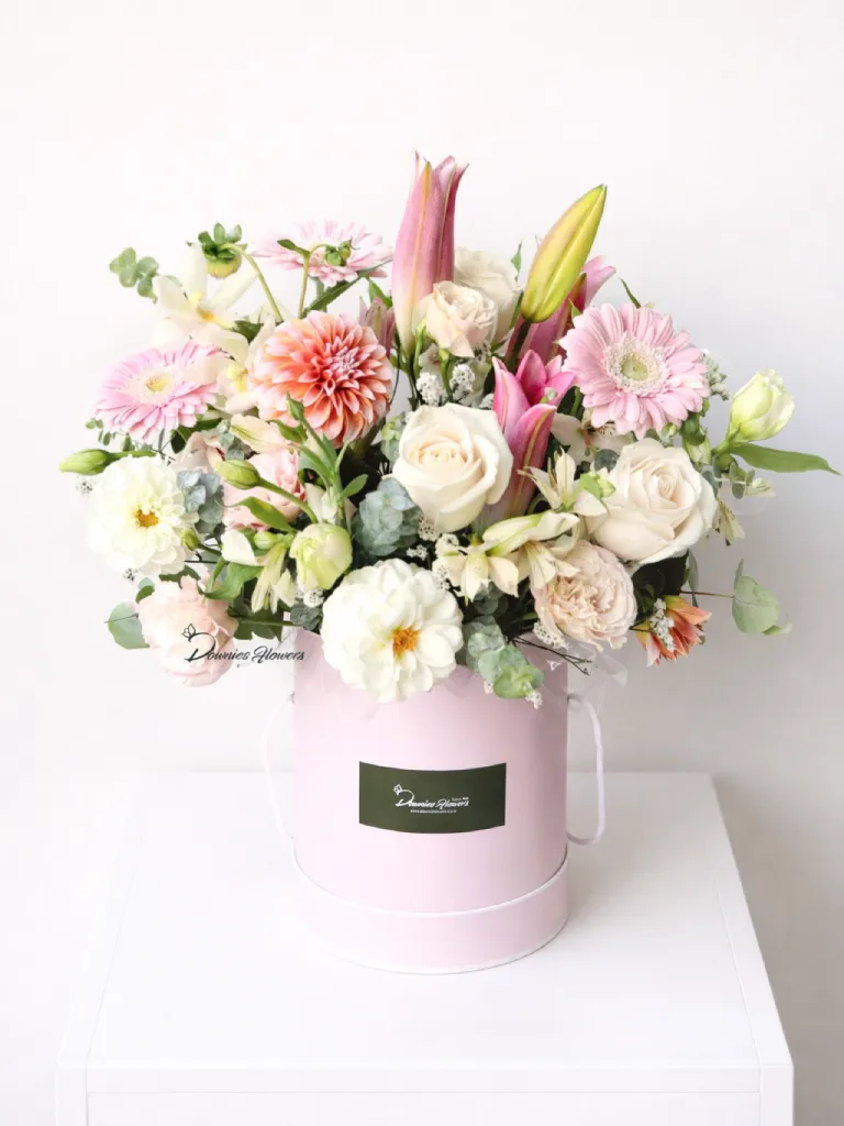 garden style boxed flower arrangement soft pastel seasonal flowers hatbox